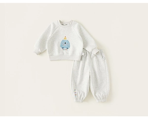 Close-up of children's cotton tracksuit with cute monster graphic and soft knit texture