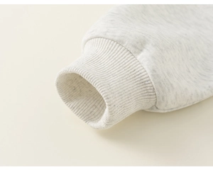 Close-up of light grey sweatshirt ribbed cuffs showing high-quality knit texture