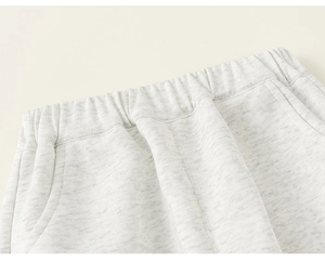 Detail of kids grey joggers showing elastic waistband and side pocket stitching
