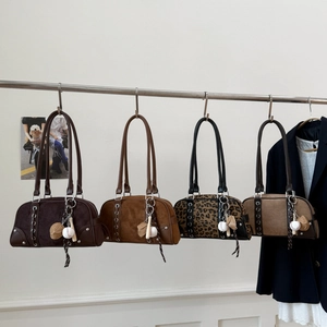 Detail of four retro Boston bags in brown and leopard print with baseball charms