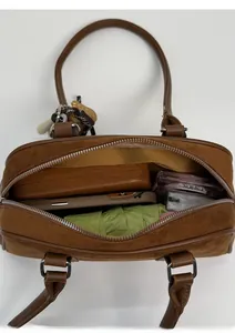 Top view of brown suede Boston bag showing spacious interior with phone and umbrella