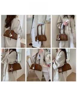 Detailed views of brown suede shoulder bag with metal eyelets and decorative sphere charm