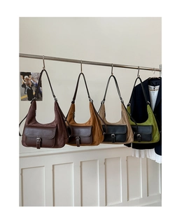 Detail view of vintage matte hobo bags showing mixed texture fabrics and retro buckle pockets