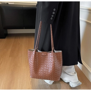 Brown woven leather tote bag detail showing luxury Intrecciato craftsmanship and texture