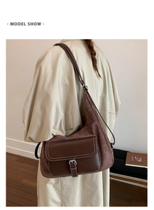 Detail of vintage matte brown dumplings bag showing the buckle flap and leather texture