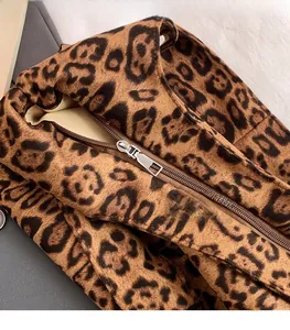 Detail shot of the plush leopard print fabric and high-quality silver metal zipper