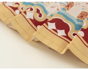 Macro view of Chinese New Year cloak fabric with traditional cloud patterns and gold trim