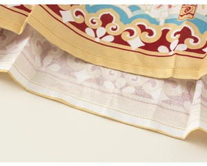 Detailed view of Chinese style embroidery featuring clouds and rabbit patterns on fabric