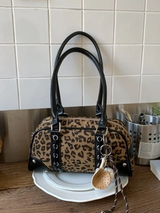 Leopard print boston shoulder bag with baseball charm and sleek black leather trim