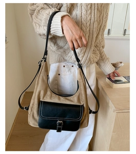 Detail of khaki frosted suede hobo bag with black leather flap and shoulder strap