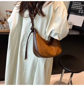 Retro suede hobo bag with dark brown leather piping and knotted strap detail