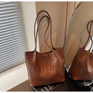 Detail of classic brown woven texture and premium craftsmanship on large tote bag
