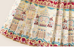 Detailed view of traditional Chinese red pleated skirt with golden lantern patterns