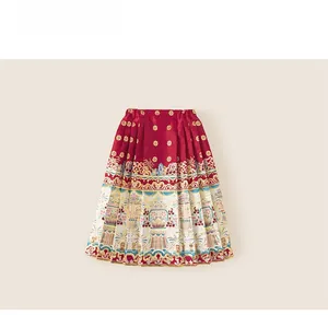 Detail showing the intricate golden lotus and cloud patterns on red satin Mamian skirt
