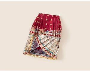 Detailed macro view of girls' red Chinese New Year skirt with traditional gold patterns