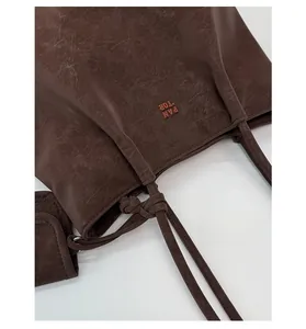 Detail of coffee brown tote bag with vintage PU leather texture and side coin pouch