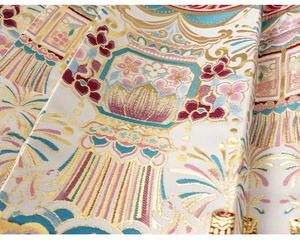 Detail of traditional Chinese embroidery fabric with rabbits and floral patterns
