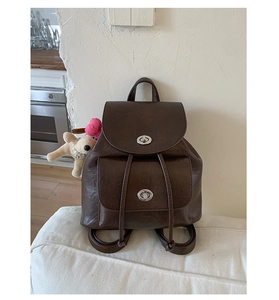 Nahaufnahme des braunen Vintage-Rucksacks mit Drehverschlüssen und kleinem Anhänger