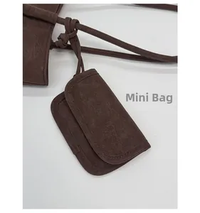 Detailed macro view of dark brown leather mini pouch with retro texture and fine stitching