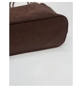 Close-up of dark brown tote bag reinforced base with premium vintage textured leather