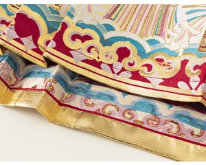 Detail of traditional Chinese brocade fabric with golden rabbit and cloud patterns