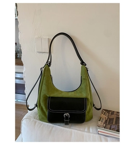 Detail of green frosted suede bag with black flap pocket and stylish buckle decoration