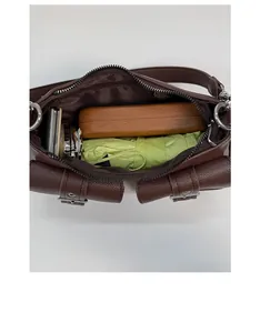 Spacious interior of dark brown pebble leather shoulder bag with daily essentials