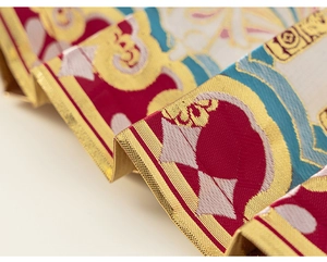 Detailed close-up of premium brocade fabric with traditional Chinese jacquard patterns
