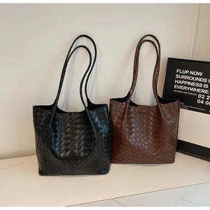 Close-up of woven texture on black and brown leather tote bags for daily commute