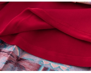 Close-up of red velvet fabric and traditional colorful wave embroidery on the Chinese New Year coat