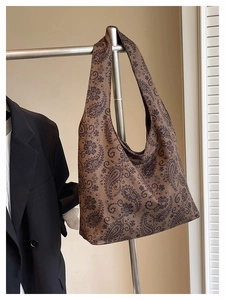 Detail of bohemian paisley print tote bag hanging on a rack for office or daily use