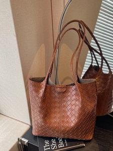 Brown woven leather tote bag with large capacity and elegant woven texture for women