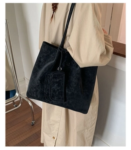 Detail shot of a black marble texture tote bag set with an adjustable shoulder strap