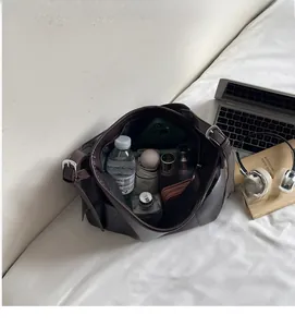 Internal view of dark brown tote bag showing large capacity for water bottle and umbrella