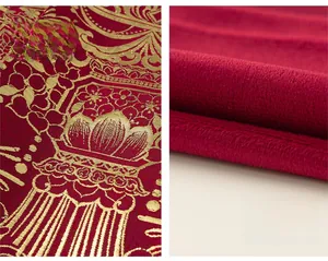 Detail of red festive brocade fabric with golden lantern pattern and warm fleece lining