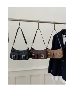 Detailed view of retro leather underarm bags in black, dark brown, and light coffee colors