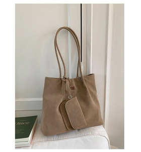 Detail of khaki tote bag with textured suede finish and matching small coin purse