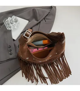 Vista interna della borsa in pelle scamosciata marrone con frange e borchie a stella