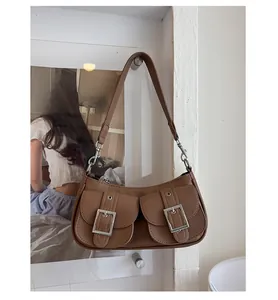 Detail of vintage brown pebbled leather underarm bag with double front utility pockets