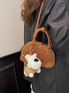 Vintage brown suede bowling bag with adjustable strap and cute white plush dog charm
