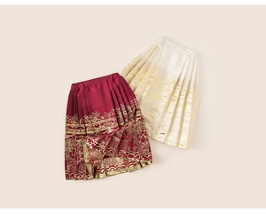 Detail of traditional Chinese pleated skirts in burgundy and cream with gold embroidery