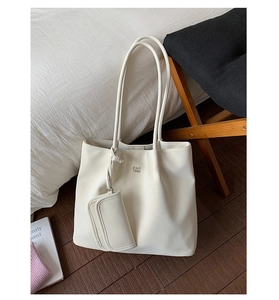 Detailed view of cream leather tote bag with matching pouch and Pantor logo branding