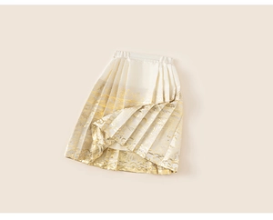 Detailed close-up of white pleated skirt with gold traditional patterns and waistband