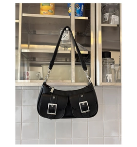 Detail of black pebbled leather shoulder bag with silver hardware and twin front pockets