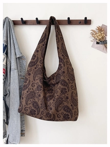 Detail of large canvas tote bag featuring vintage paisley pattern and floral print