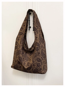 Macro detail of Bohemian paisley print on large canvas tote bag with soft shoulder strap