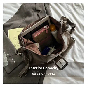 Detail view of large brown tote bag showing spacious interior with tablet and wallet