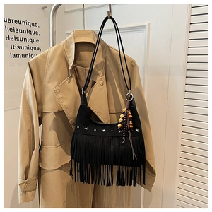 Detail of black fringe bag with silver star studs and colorful wooden bead tassel charm