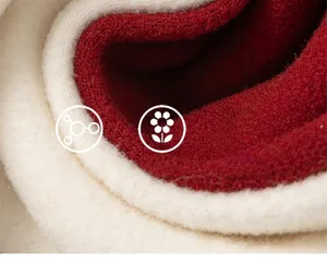 Close-up of soft red and beige knit fabric showing thick texture and skin-friendly fibers