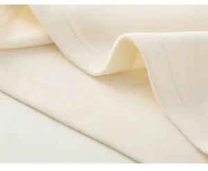 Close-up of high-quality stitching and thick off-white fleece fabric on kids winter cloak